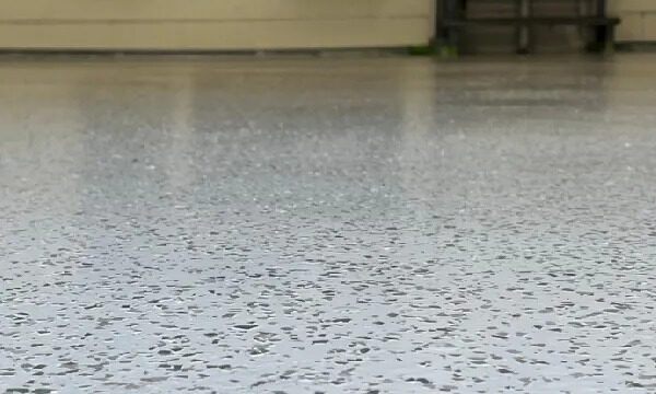 low-angle-shot-of-a-shiny-light-gray-epoxy-garage-floor-with-small-dark-flakes.webp.bv_resized_ipad.webp.bv_